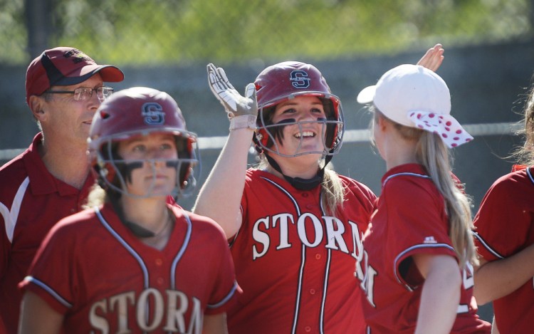 Abbie Murrell of Scarborough receives congratulations Tuesday after lining a home run during a 15-0, five-inning victory at Windham. Murrell finished with five RBI and, on top of that, allowed one hit in four innings in a game against an undefeated opponent.