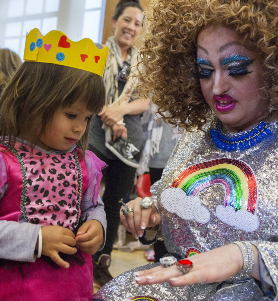 Lil Miss Hot Mess, right, compares outfits with Eva McInnes, 2, after Drag Queen Story Hour Tuesday.