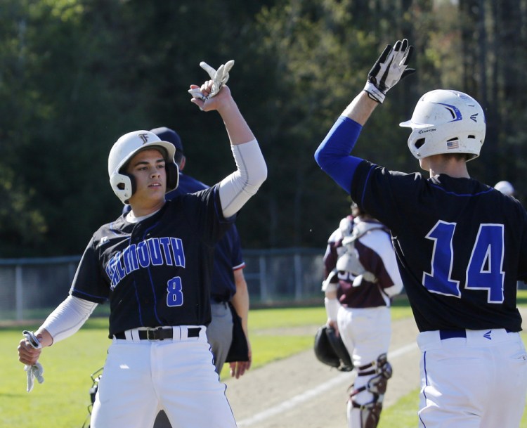 Falmouth's Garrett Aube celebrates with Robbie Armitage after scoring a run in the third inning. The Yachtsmen scored three times in the inning and won 4-0.