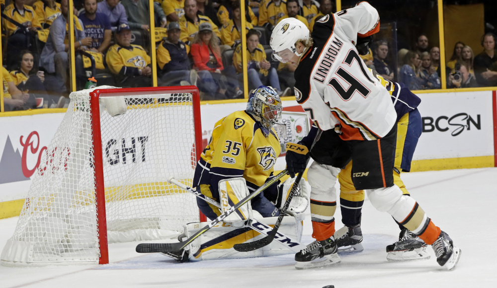 Hampus Lindholm of the Anaheim Ducks attempts to control the puck in front of Nashville goalie Pekka Rinne during the first period of Nashville's 2-1 victory Tuesday night in Game 3 of the Western Conference finals.