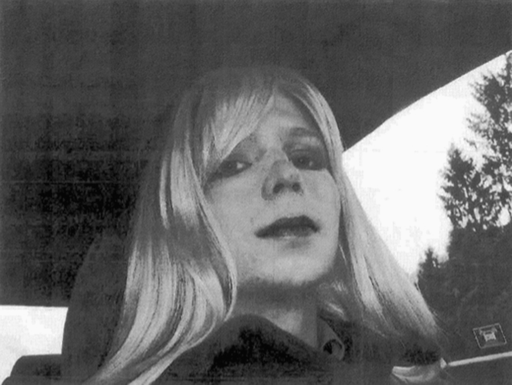 In this undated file photo provided by the U.S. Army, Pfc. Chelsea Manning poses for a photo wearing a wig and lipstick. Manning, the transgender soldier convicted in 2013 of illegally disclosing classified government information, was released from prison Wednesday.