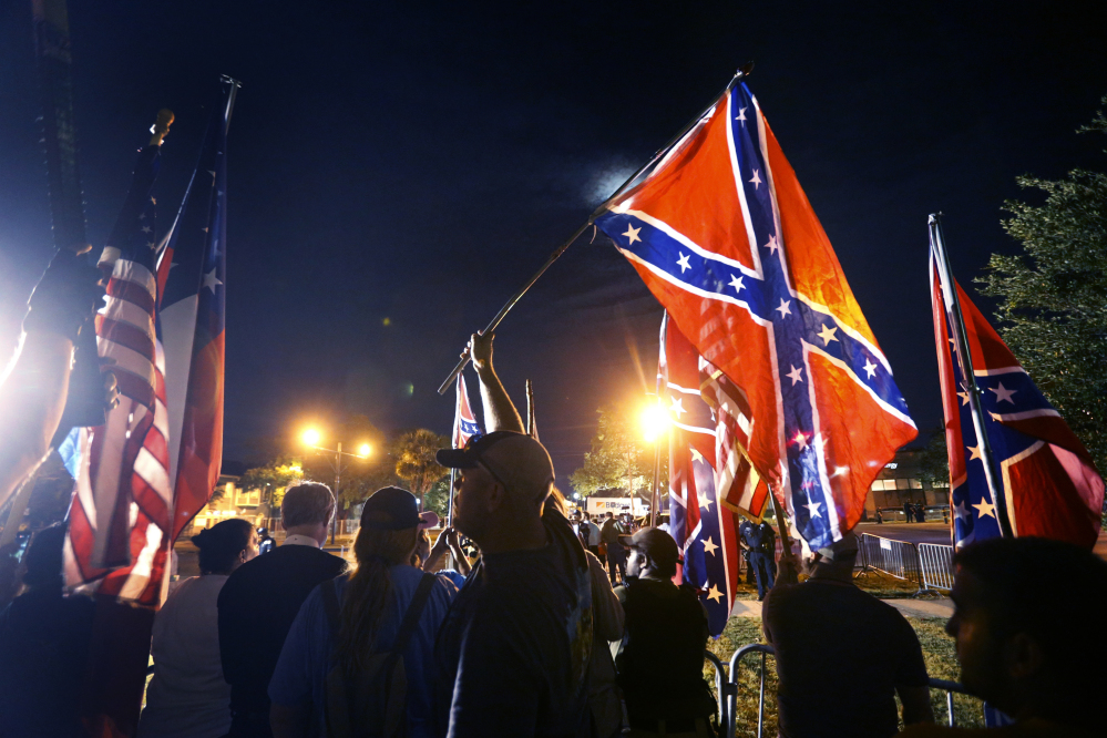 Demonstrators who supports keeping Confederate era monuments protest before the Jefferson Davis statue was taken down in New Orleans, Thursday, May 11, 2017. (AP Photo/Gerald Herbert)