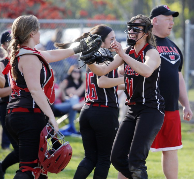 Wells pitcher Anya Chase, right, celebrates with her teammates after finishing a 1-0 victory Thursday against Western Maine Conference rival Greely.