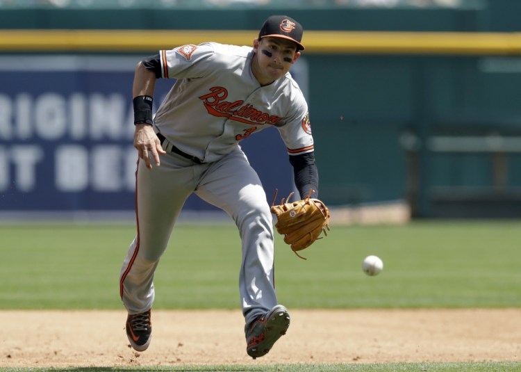 Ryan Flaherty, the Portland native playing third base for the Baltimore Orioles, charges a single hit by Nick Castellanos of the Tigers in Detroit's 6-5 victory Thursday. Flaherty went 1 for 4.