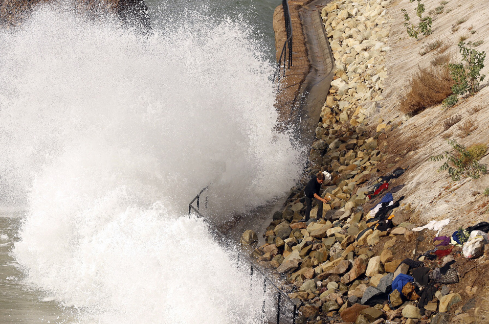 High surf crashes into the sea wall at Will Rogers State Beach in Pacific Palisades. Waves can enhance flooding, scientists say.
