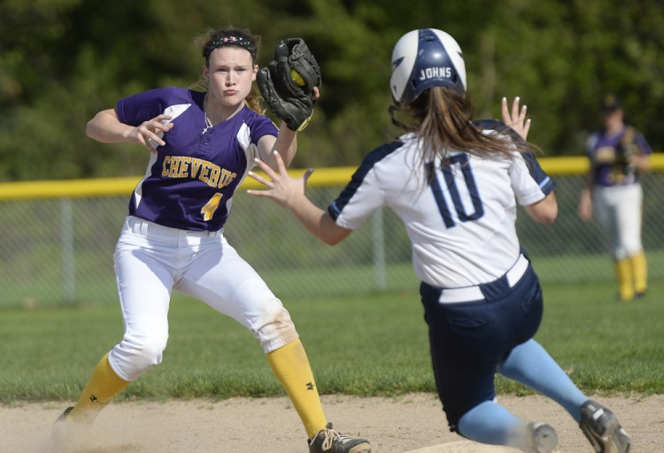 Alex Hammond of Cheverus/North Yarmouth Academy prepares to tag out Angelica Johns of Westbrook, who was caught stealing Friday. Westbrook earned a 15-7 victory at home.