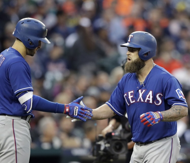 The Rangers' Mike Napoli, right, is greeted by teammate Joey Gallo after hitting a solo home run during a 5-3 win over the Tigers on Friday night in Detroit.