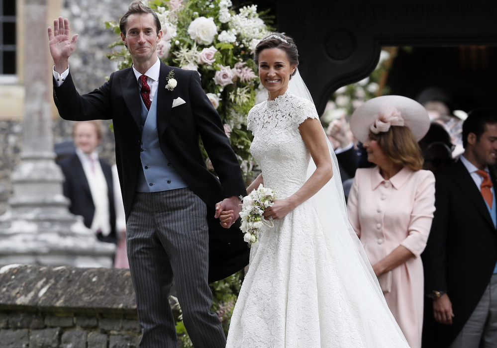 Pippa Middleton, sister of Kate, Duchess of Cambridge, and James Matthews smile for the cameras after their wedding at St. Mark's Church in Englefield, England, on Saturday.