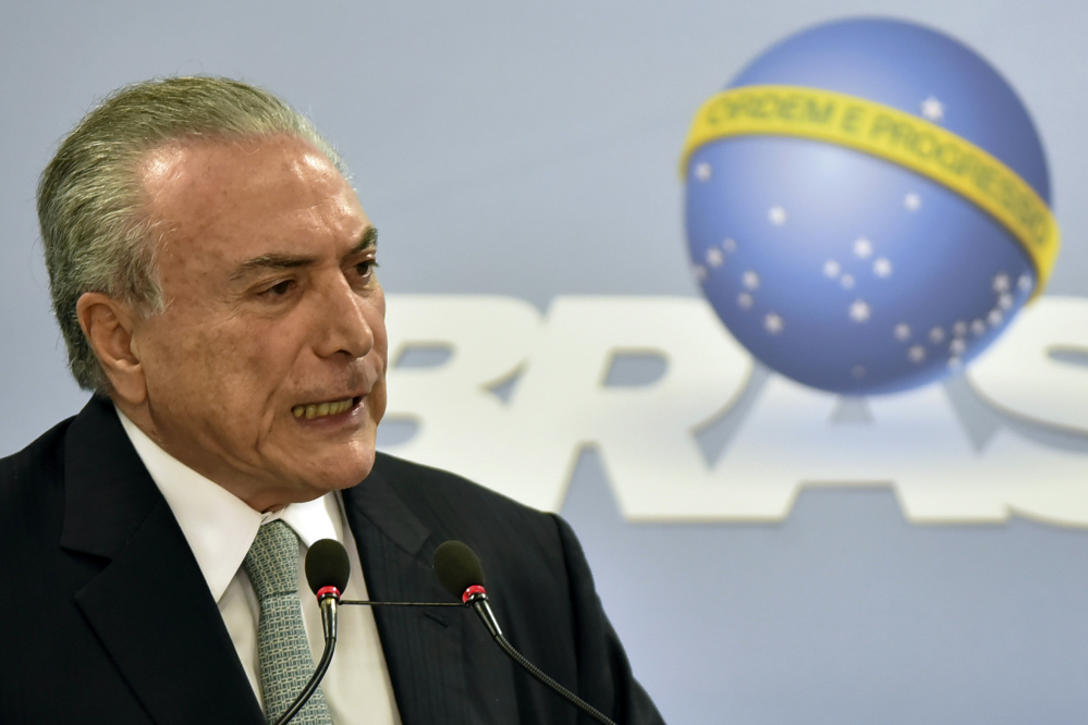 Brazil's President Michel Temer says he will fight allegations that he endorsed the paying of hush money to an ex-lawmaker jailed for corruption, during a national address at the Planalto presidential palace in Brasilia, Brazil, Thursday.
