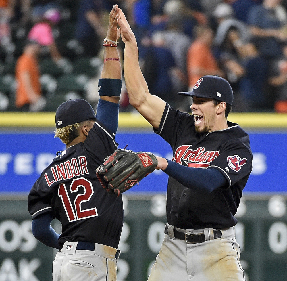 Francisco Lindor, left, and Bradley Zimmer of the Cleveland Indians celebrate Saturday after the 3-0 victory against the Houston Astros.