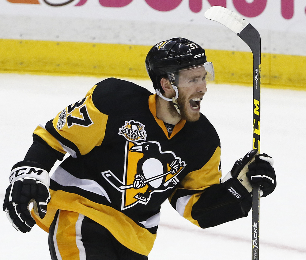 Carter Rowney of the Penguins celebrates after assisting on a goal by Scott Wilson during the first period of Game 5 of the Eastern Conference finals. Pittsburgh scored four goals in the first on the way to a 7-0 win.