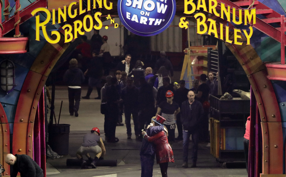 Ringling Bros. ringmaster Kristen Michelle Wilson, center right, hugs a crew member after the final show by one of the circus' two touring units May 7 in Providence, R.I.