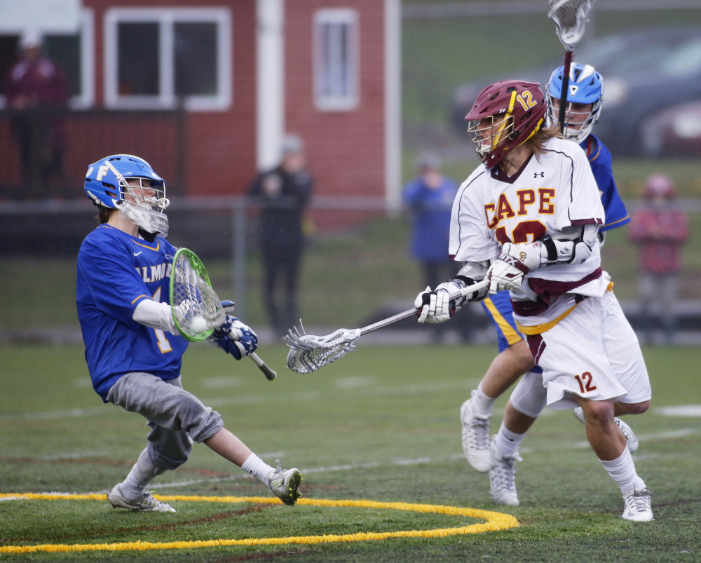 Liam Tucker of Falmouth makes a save on a backhand shot by Owen Thoreck of Cape Elizabeth on April 25.  
