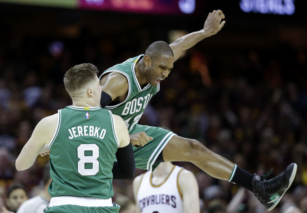 Celtics' Jonas Jerebko celebrates with Al Horford during the second half of Game 3 of the NBA Eastern Conference finals Sunday in Cleveland. The Celtics won 111-108.