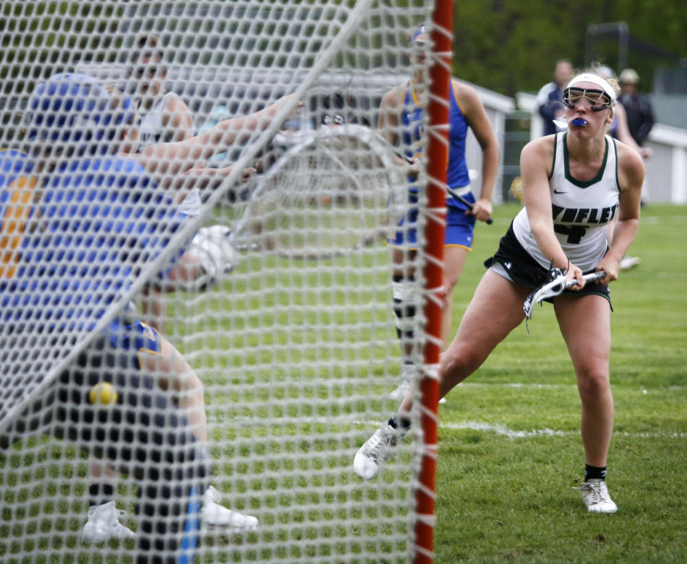 Laura Baginski of Waynflete watches as her shot gets past goalie Maddie Nelson of Lake Region in the second half. Baginski finished with three goals, including the winner in the second overtime.