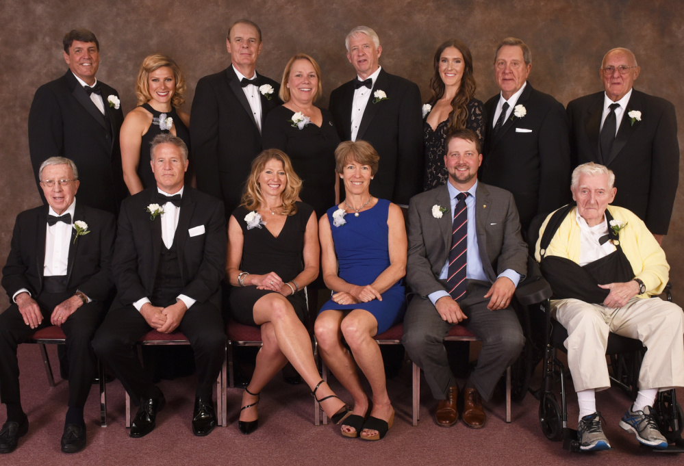 The Maine Sports Hall of Fame inducted its 2017 class at Merrill Auditorium in Portland on Sunday. The 13 inductees, from left to right: Front row – Tom Reynolds (ski coaching), Brett Brown (basketball), Angela Bancroft (triathlon), Leslie Bancroft (Nordic skiing), Ian Crocker (swimming) and Bob Bahre (auto racing). Back row – Jay Hutchins (soccer), Anna Willard (track and field), Kyle Hutchins (soccer), Dan Burke (Sea Dogs founder, represented by his daughter, Sally McNamara), Dick Capp (football), Sarah Marshall Ryan (basketball), Norm Gagne (hockey) and Glenn Hutchins (soccer).