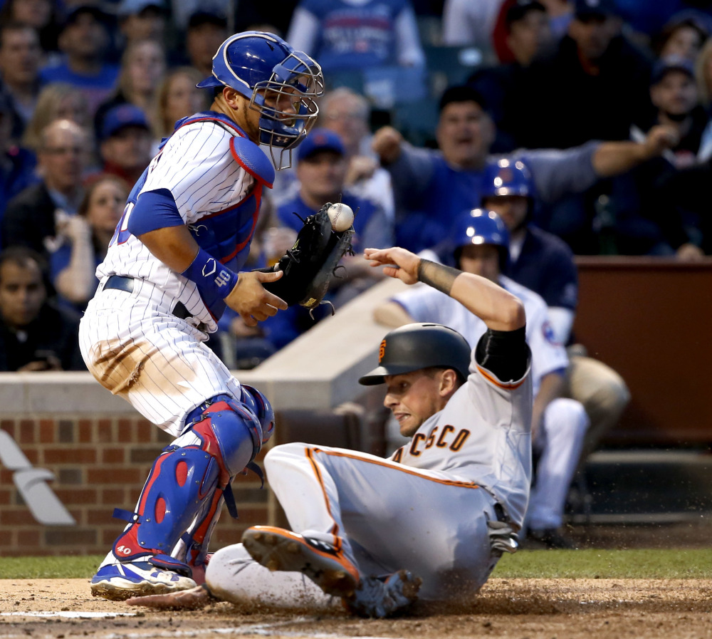 San Francisco's Joe Panik scores in front of Chicago Cubs catcher Willson Contreras during the third inning of a 6-4 win by the Giants Monday at Wrigley Field in Chicago.