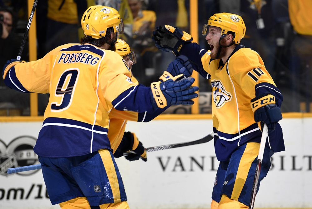 The Nashville Predators were in high spirits Monday night, as Filip Forsberg, left,  Pontus Aberg, center, and  Colton Sissons celebrate a third-period goal during a 6-3 win over the Anaheim Ducks to win the Western Conference Final at Nashville, Tenn., on Monday.