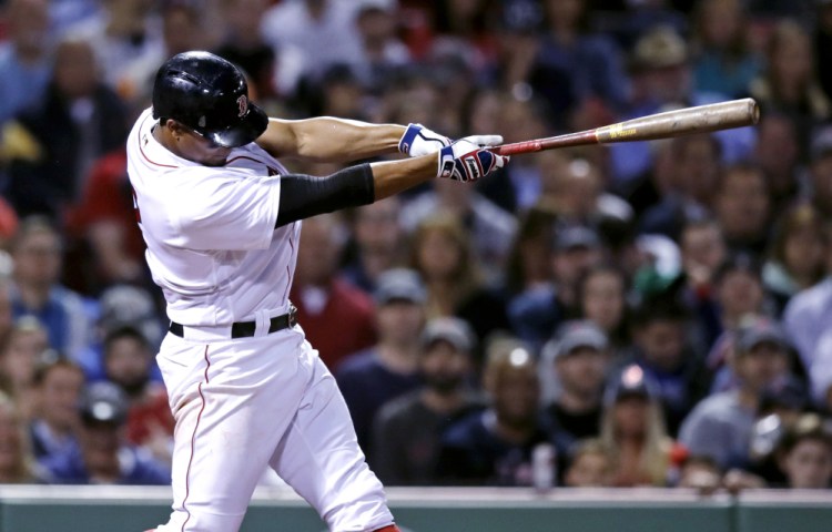 Boston's Xander Bogaerts follows through on his two-RBI single during the fifth inning Tuesday against the Texas Rangers at Fenway Park in Boston.