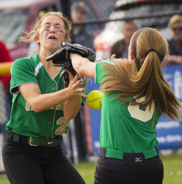 Olivia Ducharme, left, and Sarah Howe of Massabesic attempt to haul in an infield fly Wednesday during their SMAA softball game against undefeated Scarborough. The Red Storm ended the game with a nine-run sixth inning for a 13-1 victory at home.