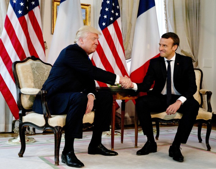 President Trump meets with French President Emmanuel Macron at the U.S. ambassador's residence in Brussels, Thursday for talks and an epic handshake.