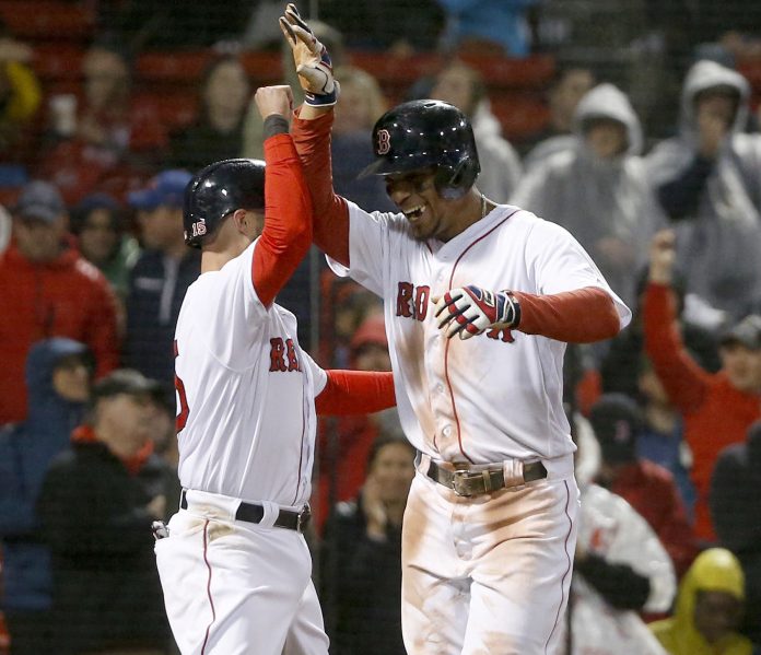 Boston's Xander Bogaerts, right, celebrates with Dustin Pedroia after hitting a two-run homer in the third inning Thursday night at Fenway Park.