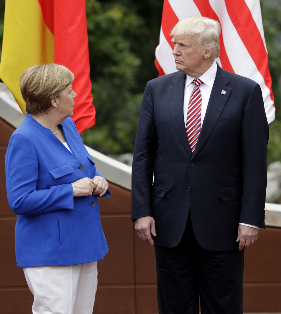 German Chancellor Angela Merkel speaks with President Trump during a group photo at the G-7 summit in the Ancient Theatre of Taormina in the Sicilian citadel of Taormina, Italy, on Friday. In January, Trump said that German car manufacturers like BMW could face U.S. tariffs of up to 35 percent if they set up plants in Mexico instead of in the U.S. and try to export the cars to the U.S.