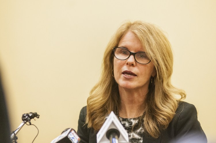 Health and Human Services Commissioner Mary Mayhew reads a statement about her resignation to reporters on May 26 at the department headquarters in Augusta. 