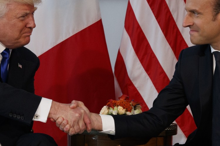 President Trump and French President Emmanuel Macron shake hands Thursday during a meeting at the U.S. Embassy in Brussels. The two men shook hands for six long seconds while Trump twice tried to release his grip.