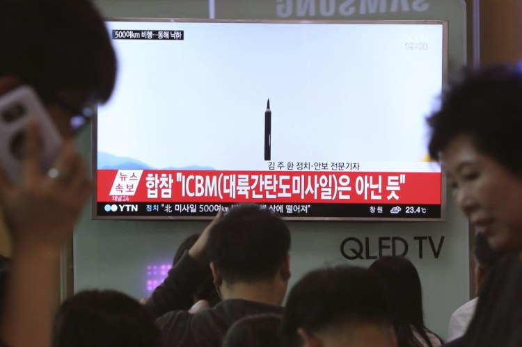 People watch a TV news program showing a file image of a missile launch conducted by North Korea, at the Seoul Railway Station in Seoul, South Korea, this month. With North Korea's nuclear missile threat in mind, the Pentagon is planning a missile defense test next week that for the first time will target an intercontinental-range missile.