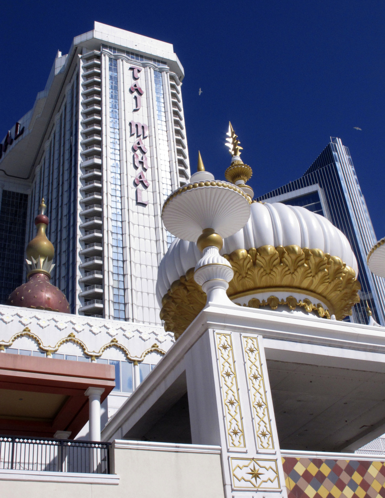 This April 5, 2017 photo shows the exterior of the former Trump Taj Mahal casino, with the name "Trump" stripped from it,  in Atlantic City N.J. Hard Rock International is upping its investment in Atlantic City's former Trump Taj Mahal casino. Company chairman Jim Allen said Hard Rock will spend at least $500 million on rebranding and reopening the shuttered casino, up from its initial $350 million plan. Hard Rock bought the Taj Mahal in March for $50 million.