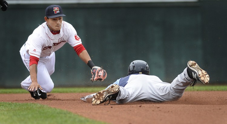 Sea Dogs shortstop Tzu-Wei Lin can't apply the tag in time as Trenton's Jake Cave slides in safely for a double Friday night at Hadlock Field. Trenton won, 8-6.