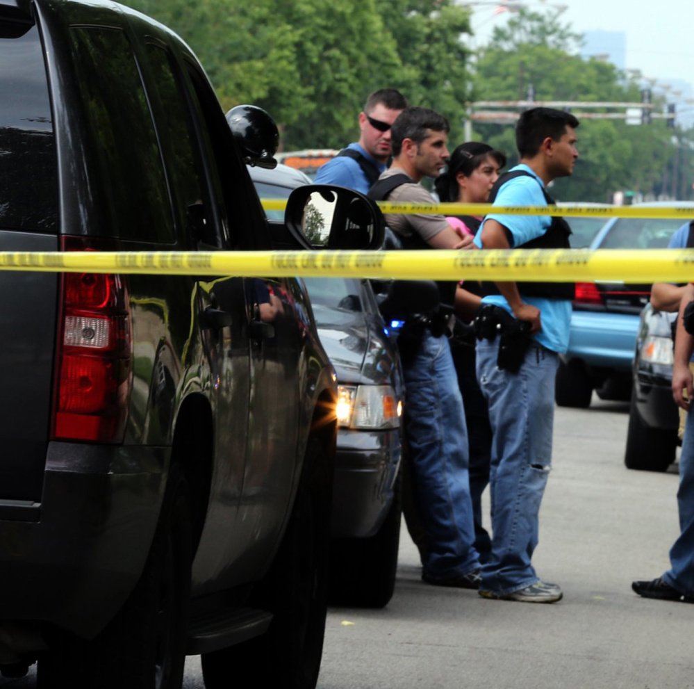 Officers at a 2013 police-involved shooting in Chicago. New research indicates that states with stricter gun laws have fewer fatal shootings of civilians by police.
Officers investigate the scene of the police-involved shooting of Christian Green, 17, in the 5600 block of South State State on July 4, 2013 in Chicago, Ill. Fatal shootings of civilians by police officers are less common in states with stricter gun laws than in states that take a more relaxed approach, a new research says. (
