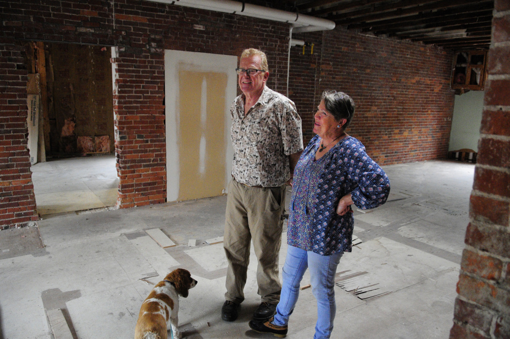 Mike Gent, left, and Cheryl Clark stand in the third floor studio on Thursday in their recently purchased building, the Milliken Block, in Gardiner.