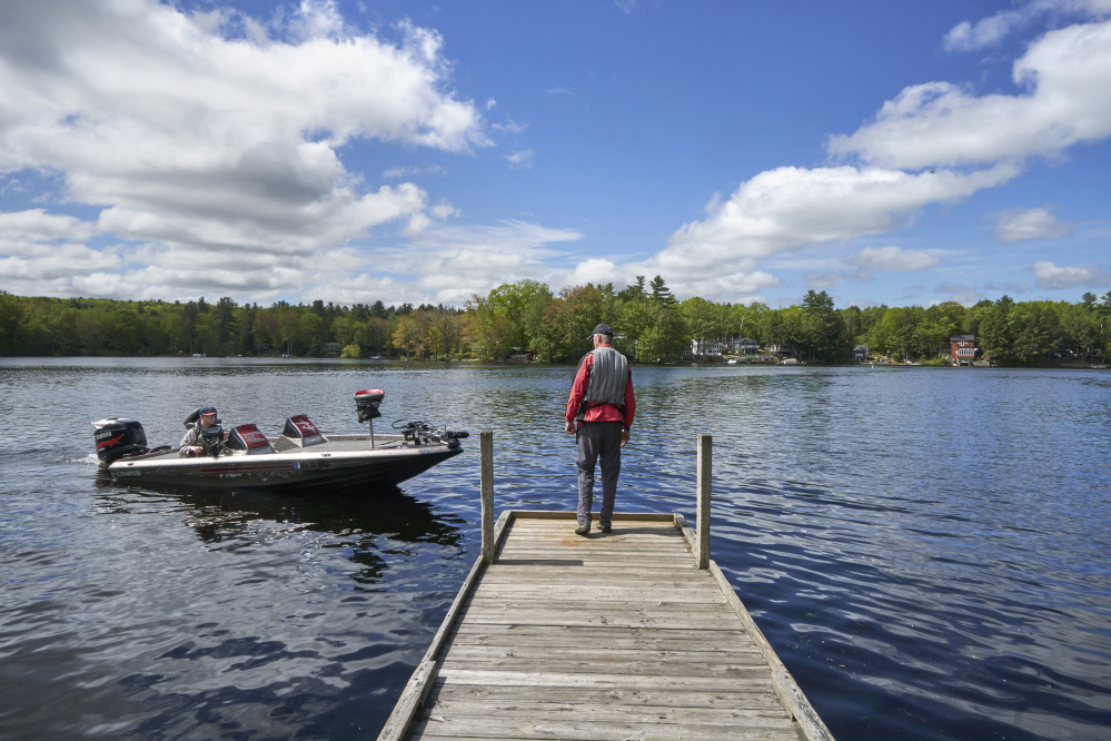 Chris Lloyd pulls in his boat to pick up his father, Don Lloyd, at the Mousam Lake launch in Shapleigh on Saturday, where a nice start to Memorial Day weekend had vessels out in number.