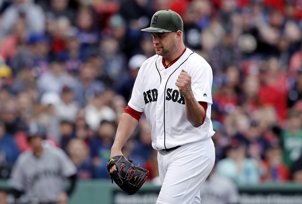 Boston starting pitcher Brian Johnson pumps his fist after completing the top of the eighth inning =against the Seattle Mariners at Fenway Park in Boston, Saturday. Johnson, who was called up from Pawtucket as a fill-in starter, threw a five-hit shutout.