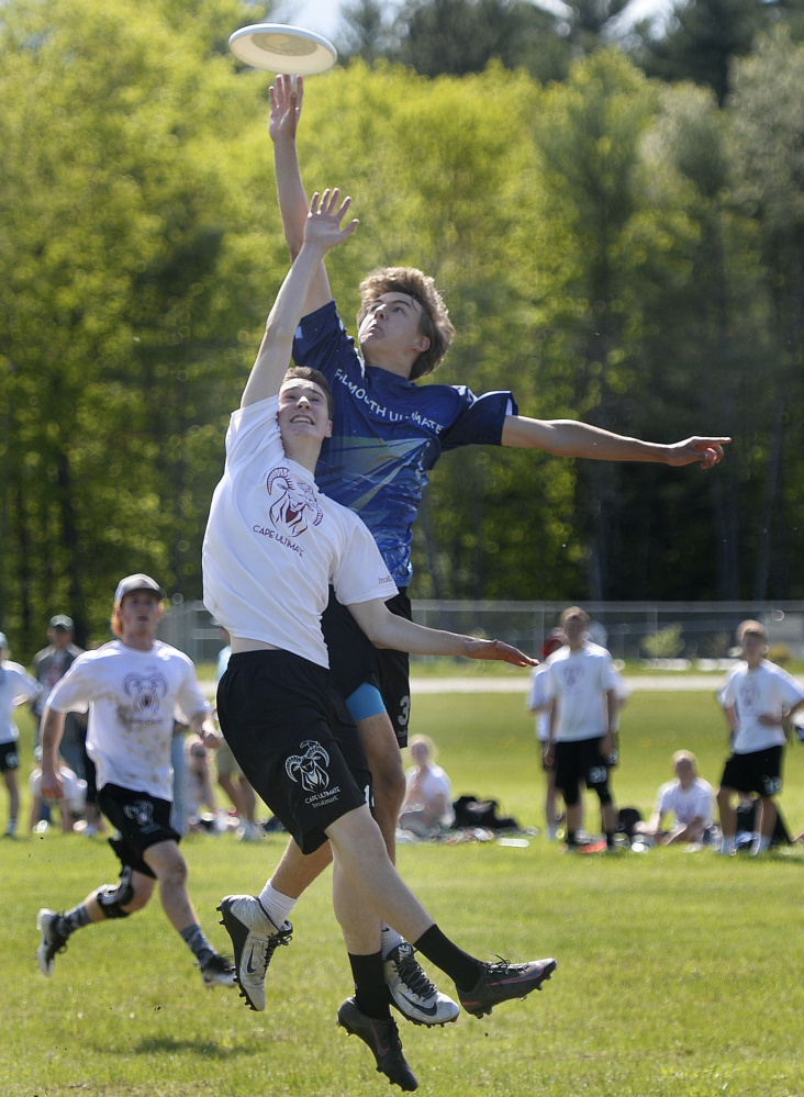 Cape Elizabeth's Calvin Stoughton, front, and Falmouth's Jack Hepburn go up for the disc during the boys' final. Falmouth captured its fourth straight championship, 15-8.