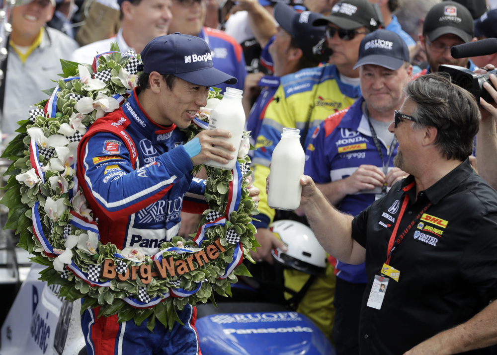 Takuma Sato, left, of Japan, toasts with car owner Michael Andretti as they celebrate after Sato won the Indianapolis 500 Sunday at Indianapolis Motor Speedway in Indianapolis.