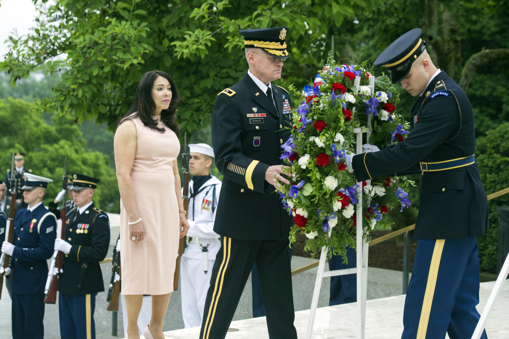 Army Maj. Gen. Michael Howard, right, and Karen Durham-Aquilera of Army National Cemeteries lay a wreath at the grave of former President John F. Kennedy in Arlington National Cemetery on Monday, the 100th anniversary of his birth.
