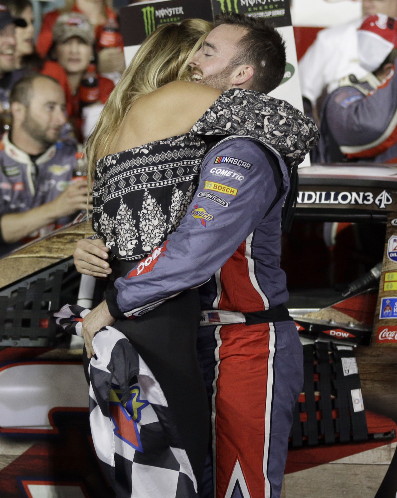 Austin Dillon celebrates with his fiancé, Whitney Ward, in Victory Lane after winning the Coca Cola 600 at Charlotte Motor Speedway in Concord, N.C., early Monday morning.