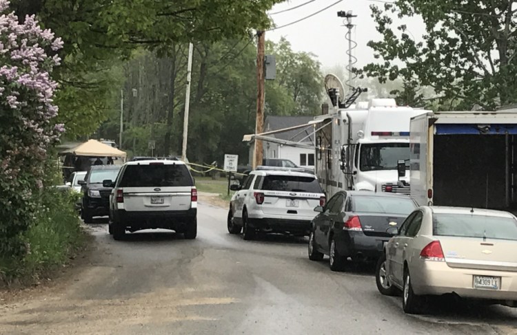Police vehicles line the road Monday near the home in Arundel where a man was fatally shot by sheriff's deputies responding to a report of a domestic dispute.