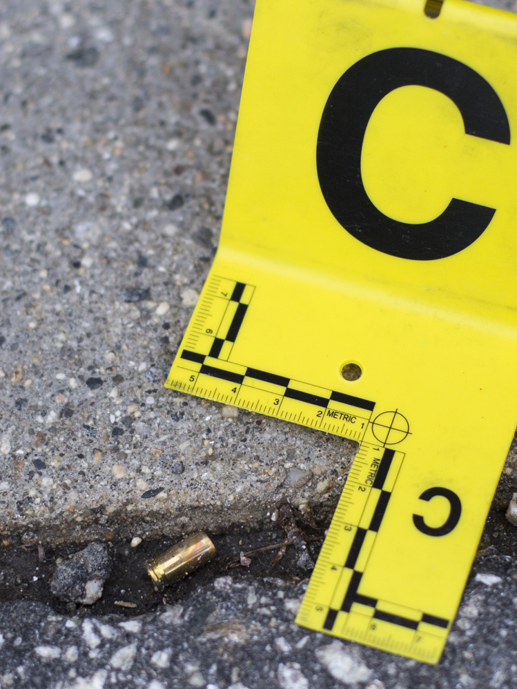 PORTLAND, ME - MAY 31: An evidence marker rests beside a bullet casing near a parking garage where a 39-year-old man was shot on Preble Street in Portland on Tuesday night. The suspect remains at large, however police don't believe the shooting was a random act or that there is any danger to the public. (Staff photo by Derek Davis/Staff Photographer)