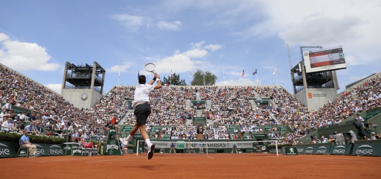 Serbia's Novak Djokovic returns the ball to Portugal's Joao Sousa during his second round win in the French Open at Roland Garros stadium in Paris on Wednesday. Djokovic, on a trial basis for now, is being advised by former American star Andre Agassi.