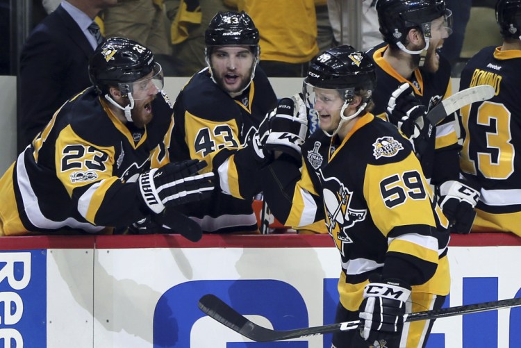 Pittsburgh's Jake Guentzel, 59, celebrates his second goal of the night against the Nashville Predators with Scott Wilson, left, and Conor Sheary, center, in the third period of Game 2 of the Stanley Cup Final Wednesday night in Pittsburgh.