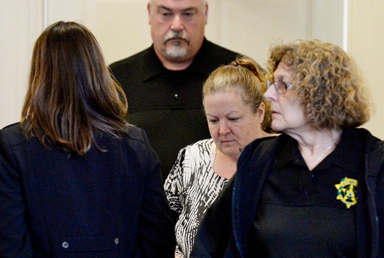 Kandee Weyland, center, is lead into York County Superior Court in Alfred on Thursday.