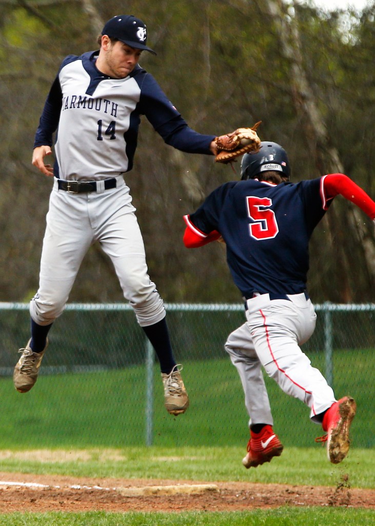 Yarmouth first baseman John Thoma tags Gray-New Gloucester's Jacob Winchester while leaping for a high throw.