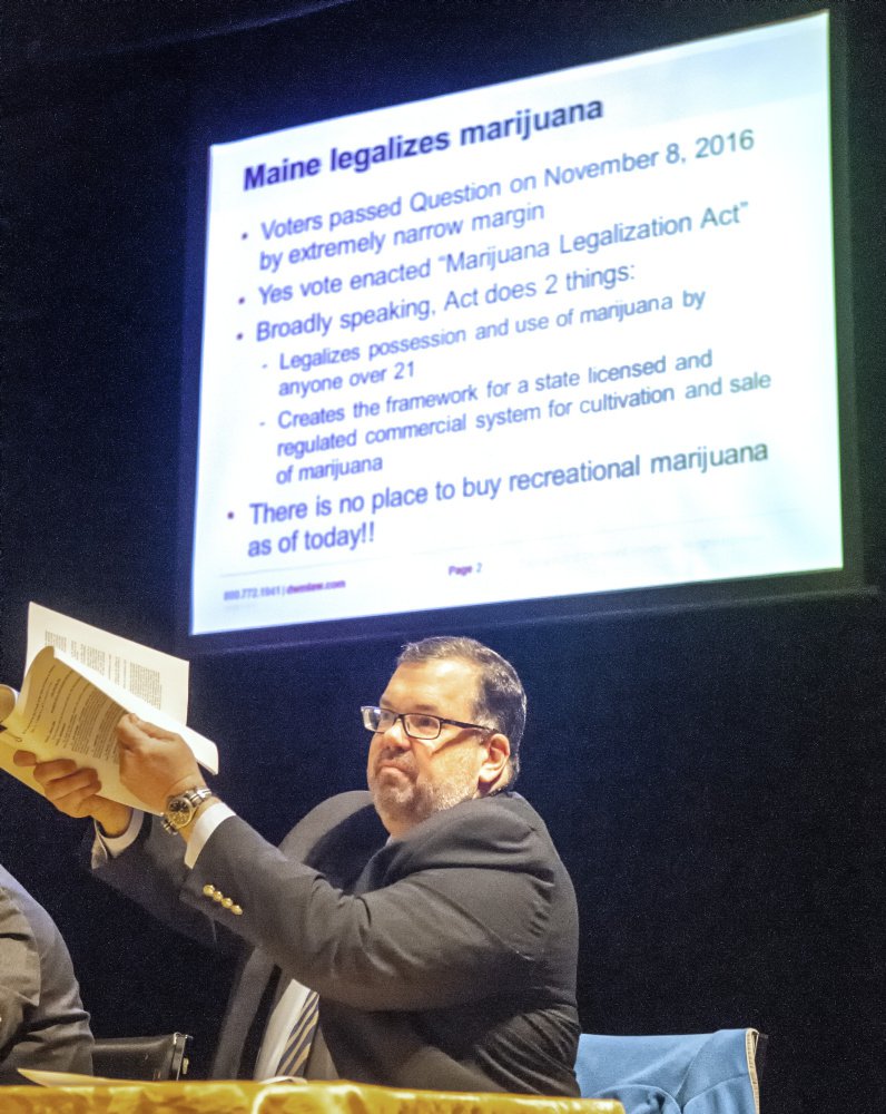 Ted Kelleher, an attorney with Drummond Woodsum, holds up the 30-page Marijuana Legalization Act during Friday's "Marijuana on Main Street" in Gardiner.