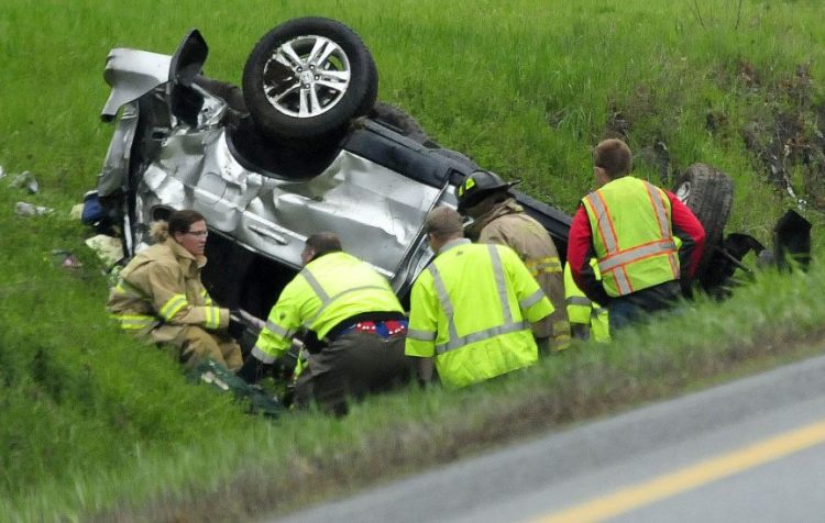 Firefighters and rescue personnel extricate the occupant of this vehicle that went off the northbound lane of I-95 in Benton and went airborne before rolling over three times on Monday. Mary Ricci of Portland was pronounced dead at the scene.