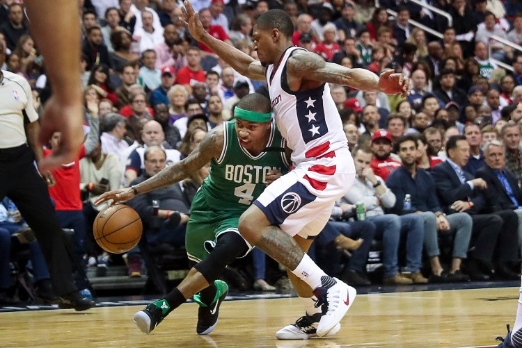 Celtics guard Isaiah Thomas drives on Wizards guard Bradley Beal in the second half of Game 3 on Thursday night in Washington. Beal says the Wizards' game plan is to be physical with Thomas and " just take him out of the game." Thomas says the officials should be calling fouls for that physical play.