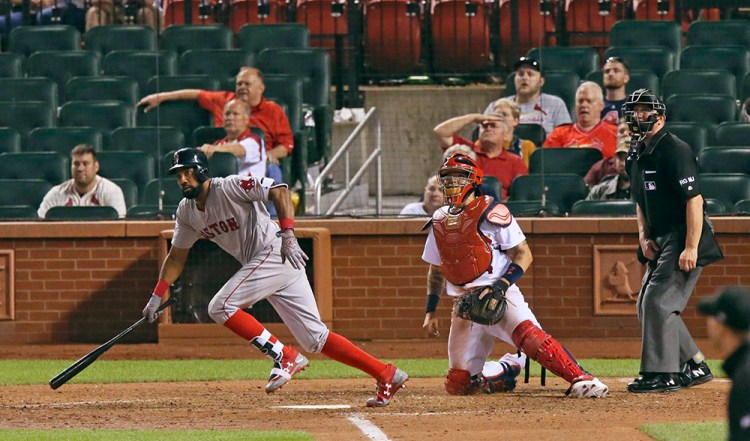 Boston Red Sox's Chris Young drives in the go-ahead run with a pinch-hit single in the 13th inning against the St. Louis Cardinals Wednesday night at Busch Stadium. 